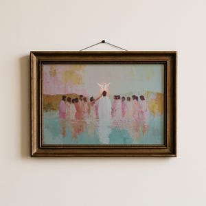 May include: Framed artwork depicting a religious scene with figures in white robes in water. A dove hovers above a central figure. The painting has a gold-colored frame and is hanging on a white wall.
