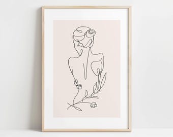 May include: A framed art print with a minimalist line drawing of a person from the back, with a flower and stem. The artwork is in black on a light beige background, encased in a natural wood frame.
