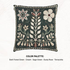 May include: A square throw pillow featuring a dark forest green background with a cream, sage green, dusty rose, and terracotta floral pattern. The design includes a central leafy stem flanked by flowers and leaves, with a decorative border.