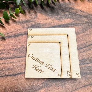 May include: A wooden square with measurements marked in inches. The square has two sets of lines, one for 2 inches, 2.5 inches, and 3 inches, and the other for 2 inches, 2.5 inches, and 3 inches. The text "Custom Text Here" is engraved on the square.
