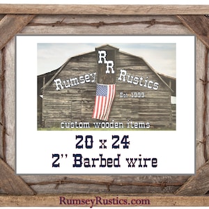 May include: A rustic wooden picture frame with a 20x24 inch opening and a 2 inch barbed wire border. The frame is made by Rumsey Rustics and features a distressed wood finish. The frame is perfect for displaying photos, artwork, or other memorabilia.