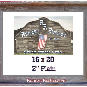 May include: A rustic wooden sign with the text "Rumsey Rustics Est. 1999 custom wooden items" and the dimensions "16 x 20 2" Plain". The sign is in front of a weathered barn with an American flag hanging from it.