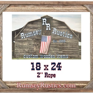 May include: A rustic wooden picture frame with a rope border. The frame is 18 inches by 24 inches and has a 2 inch rope border. The frame is made by Rumsey Rustics, a company that specializes in custom wooden items. The company's logo is visible in the image, along with the text "Est. 1999" and "custom wooden items".