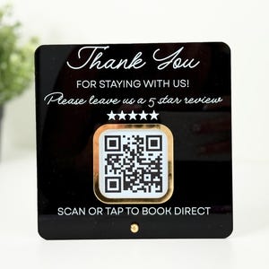 May include: Black acrylic sign with gold trim and a QR code. The sign reads "Thank You for staying with us! Please leave us a 5 star review." The bottom of the sign says "Scan or tap to book direct."