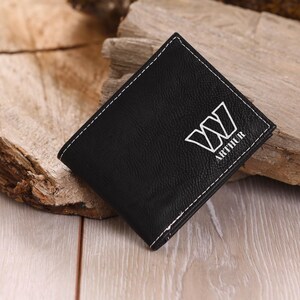 May include: Black leather wallet with white stitching and the name "Arthur" and a stylized "W" embossed on the front.