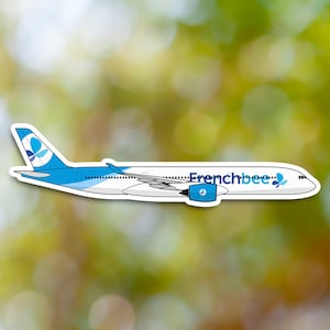 May include: A white airplane with blue accents and the text "Frenchbee" on the side. The airplane has a blue flower logo on the tail.