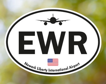 May include: White oval sticker with black text "EWR" and the words "Newark Liberty International Airport". A small American flag is below the text. A black silhouette of an airplane is above the text.