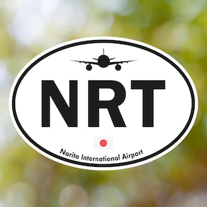 May include: Oval sticker with a white border featuring the letters "NRT" in black, a silhouette of an airplane, and the text "Narita International Airport." A red circle represents the Japanese flag.