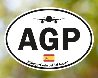 May include: Oval sticker with the letters "AGP" in bold black font, a silhouette of an airplane, and the text "Málaga-Costa del Sol Airport." Includes the Spanish flag. The sticker has a white background and a black border.