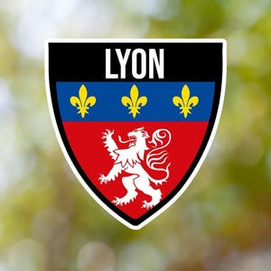 May include: A black and white shield with the word "LYON" in white letters. The shield has a red and blue background with three gold fleurs-de-lis and a white lion.