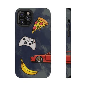 May include: A phone case with a dark blue background featuring illustrations of a pizza slice, a white game controller, a red sports car, and a yellow banana. The case has a black camera module.