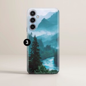May include: A phone case with a scenic image of a misty forest and a river winding through it. The image is in shades of blue and green.