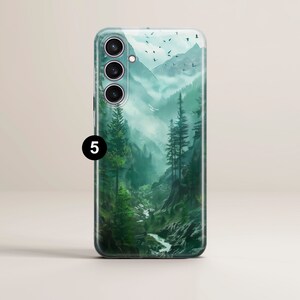 May include: A clear phone case with a green mountain and forest scene. The case has a raised camera bump with three lenses.