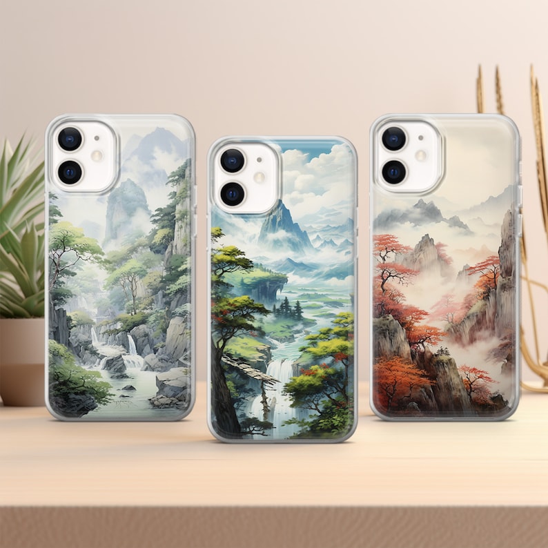 three iphone cases sitting on top of a table