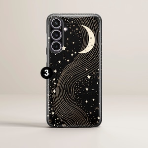 May include: A black phone case with a crescent moon and stars design. The case has a clear back and a black border. The design is in gold.