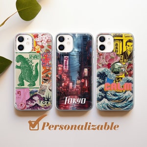 May include: Three clear phone cases with Japanese-themed designs. One features a green Godzilla, another a Tokyo street scene, and the third a wave pattern with the word "CALM". The word "Personalizable" is also visible.