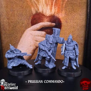 May include: Three gray Prussian Commando figurines. One is kneeling and aiming a rifle, another stands with a rifle and a cross, and the third wears a gas mask. The text "+ PRUSSIAN COMMANDO+" is at the bottom.