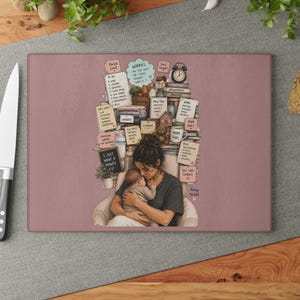 May include: A rectangular glass cutting board with a mauve background featuring an illustration of a person holding a baby. Behind them is a stack of items including sticky notes with text like To Do, Worries, and I Just Want A Minute, plus books.