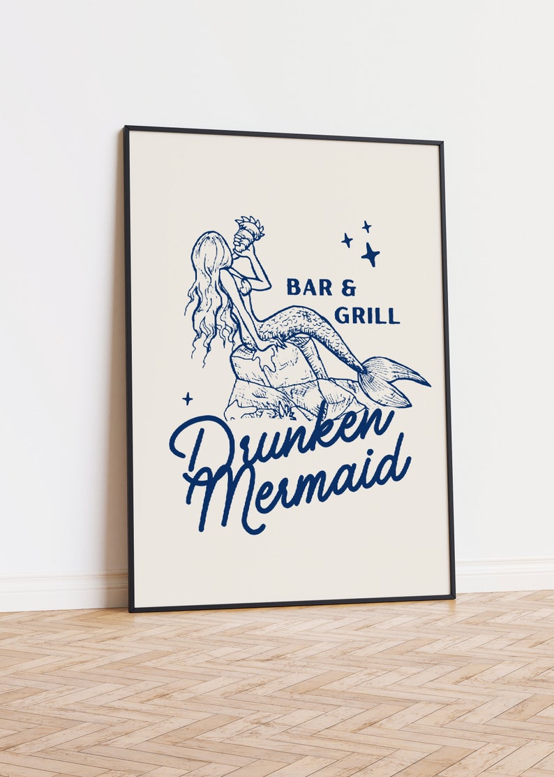 May include: A framed illustration of a mermaid drinking from a seashell with the text "Bar & Grill Drunken Mermaid" in blue.