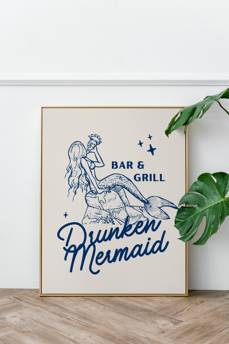 May include: A framed illustration of a mermaid drinking from a seashell with the text "Drunken Mermaid Bar & Grill" in blue lettering on a beige background.