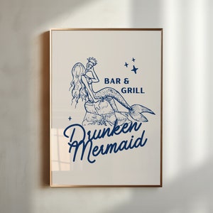 May include: A blue and white illustration of a mermaid holding a seashell, sitting on a rock. The text "Bar & Grill" and "Drunken Mermaid" is below the mermaid.
