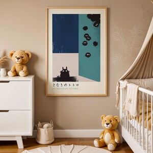A nursery room with a crib, a dresser, and a framed poster on the wall. The poster features a cat and the text "My Neighbor Totoro".