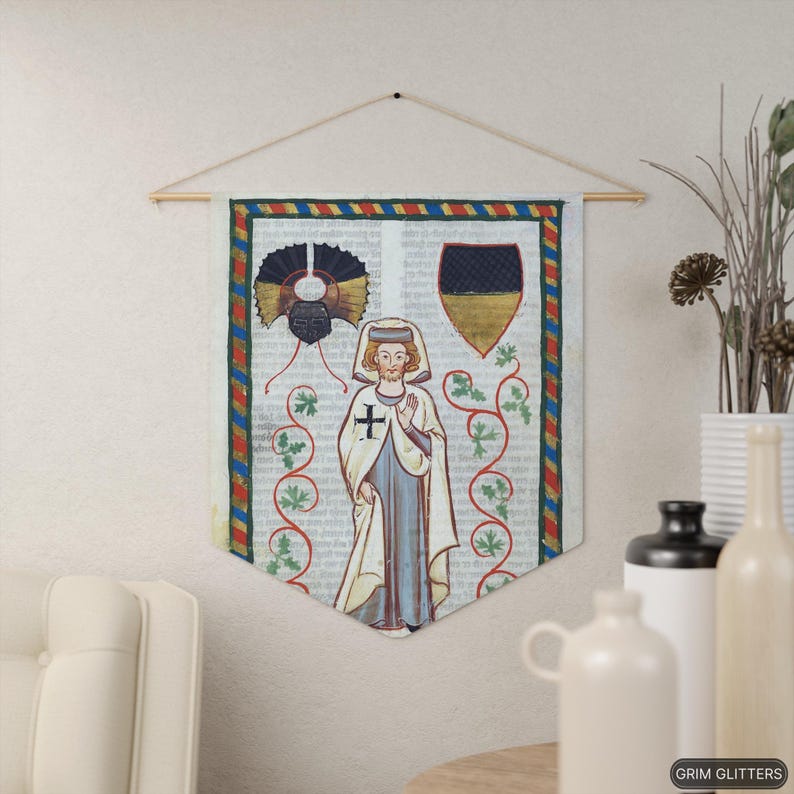 May include: A medieval tapestry featuring a depiction of a person in a white robe with a red cross on the chest. The person is standing in front of a vine with green leaves and a shield with black and gold colors. The tapestry has a red, yellow, and blue border.
