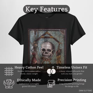 May include: Black t-shirt with a vintage-style image of a skull and crossbones. The image is surrounded by a decorative frame. The t-shirt features a heavy cotton feel, a timeless unisex fit, and precision printing.