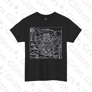 May include: Black t-shirt with a detailed white graphic featuring the word "LUCIFERO" and a complex illustration of a figure with multiple faces and other symbolic elements. The design is framed within a rectangular border.