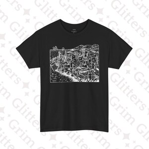 May include: Black t-shirt featuring a detailed white illustration of a coastal city with towers, buildings, and water. The design is reminiscent of an old woodcut print. The shirt has a crew neck and short sleeves.