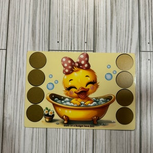 May include: A yellow duckling with a pink bow sits in a yellow bathtub with bubbles. The duckling is smiling and has its wings outstretched. The background is a light yellow with gold circles around the edges. The text "Sterns on a Budget Save $50" is at the bottom of the image.