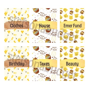 May include: Six rectangular labels featuring Winnie the Pooh themes. The labels display the text Clothes, House, Emer Fund, Birthday, Taxes, and Beauty. The designs include honey pots, bees, honeycombs, and Winnie the Pooh character faces.