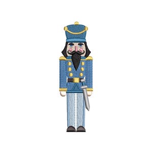 May include: A blue and gold nutcracker soldier with a black mustache and beard, wearing a hat and holding a sword. The nutcracker has a detailed design with gold accents and is standing upright.