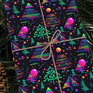 May include: A black gift box wrapped in neon green, pink, and blue Christmas tree patterned wrapping paper. The box is tied with twine.