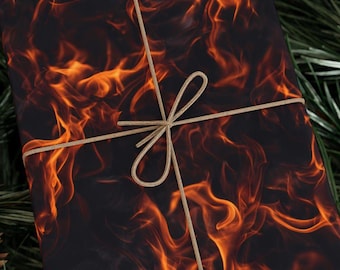 May include: A wrapped gift with a fiery flame pattern in shades of orange and black. The gift is tied with a natural-colored twine, forming a bow. The background includes a hint of green foliage.