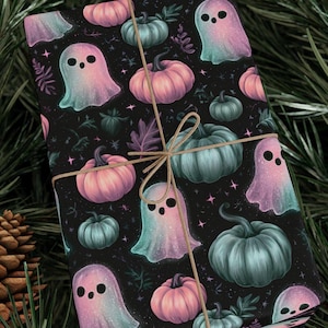 May include: A rectangular gift wrapped in black paper featuring a repeating pattern of pastel pink and teal pumpkins and ghosts, accented with small stars and tied with a thin, light brown twine string wrapped in a cross pattern.