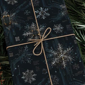 May include: A wrapped gift with black wrapping paper featuring a snowflake and circuit board design. The gift is tied with a tan twine bow. The snowflakes are white and silver, and the circuit board lines are light blue.