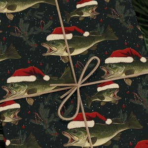 May include: A dark green wrapping paper with a repeating pattern of bass fish wearing Santa hats. The fish are green, brown, and white with red Santa hats. The background is a dark green with white snowflakes and red berries.
