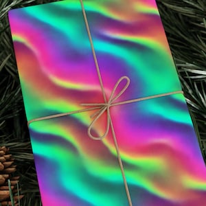 May include: A present wrapped in paper with a swirling, colourful design of pink, green, yellow, and purple. The gift is tied with natural twine, creating a festive look. The wrapping paper has a holographic effect.