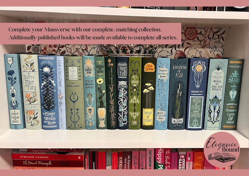 May include: A collection of decorative books with matching designs, arranged on a white shelf. The spines feature floral and geometric patterns in shades of blue, green, and gold. The text "Complete your Maasverse" is visible.