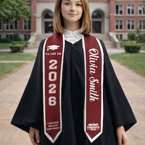 May include: A person wearing a black graduation gown with a maroon sash. The sash displays the text "Class of 2026", "Olivia Smith", and "Carnegie Mellon University". A graduation cap graphic is also visible.