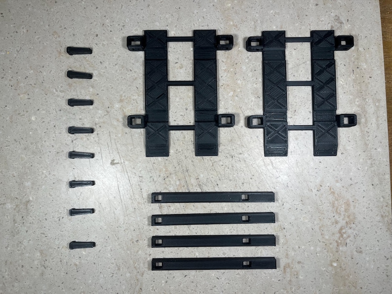 Puede incluir: Un conjunto de v&iacute;as de pl&aacute;stico negro para un tren de juguete. El conjunto incluye v&iacute;as rectas y v&iacute;as curvas.