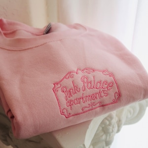 Coraline Pink Palace crewneck sweatshirt.