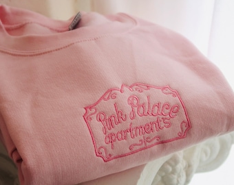Coraline Pink Palace crewneck sweatshirt.