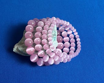 Pulsera rosa ojo de gato: joyería artesanal de piedras preciosas y cristales.