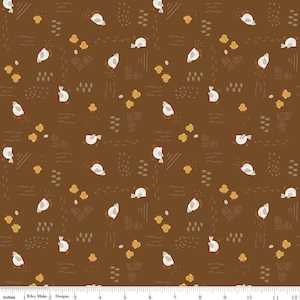 May include: Brown fabric with a repeating pattern of white chickens, yellow chicks, and eggs. The design includes small, stylized elements like wheat, footprints, and wavy lines. The text "Riley Blake Designs" is visible at the bottom.