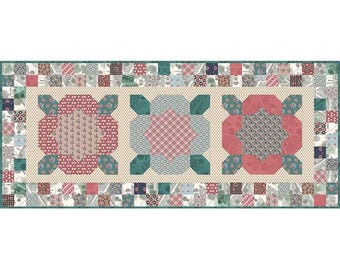 May include: A rectangular quilt with a cream background and a border of colorful patchwork squares. The center features three large, stylized floral designs in shades of pink, red, and blue, surrounded by a green and white geometric pattern.