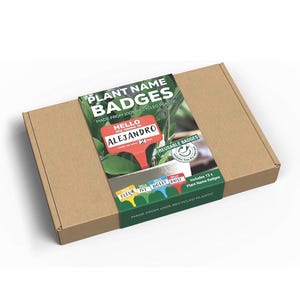 May include: A brown cardboard box with a green and white label. The label says "PLANT NAME BADGES" and features a red plant name badge with the name "ALEJANDRO." The box contains 12 reusable plant name badges made from recycled plastic.