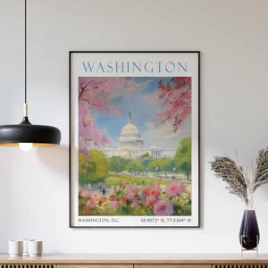May include: A vintage travel poster featuring a watercolour illustration of the United States Capitol Building in Washington, D.C. The building is surrounded by cherry blossom trees in full bloom. The poster includes the text "WASHINGTON" and "WASHINGTON, D.C. 38.9072° N, 77.0369° W".