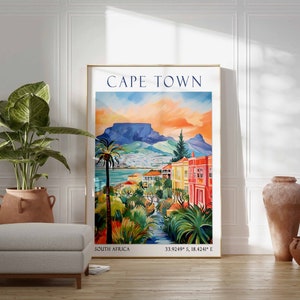 May include: A colorful vintage travel poster featuring a scenic view of Cape Town, South Africa. The poster depicts Table Mountain, palm trees, and colorful buildings. The text "CAPE TOWN" is displayed in a bold blue font at the top of the poster. The coordinates "33.9249&deg; S, 18.4241&deg; E" are displayed at the bottom of the poster.